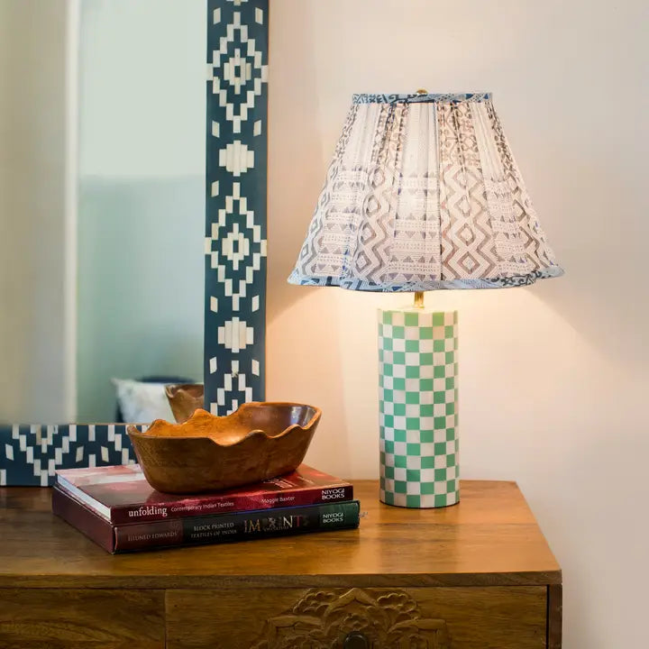 Handcrafted lamp base styled with neutral lampshade on side table