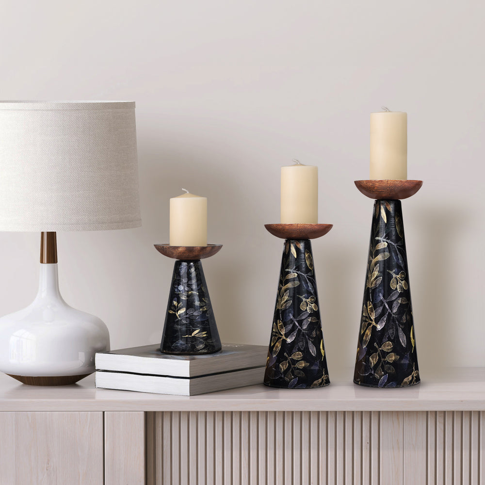 close-up of floral detailing on black candleholders
