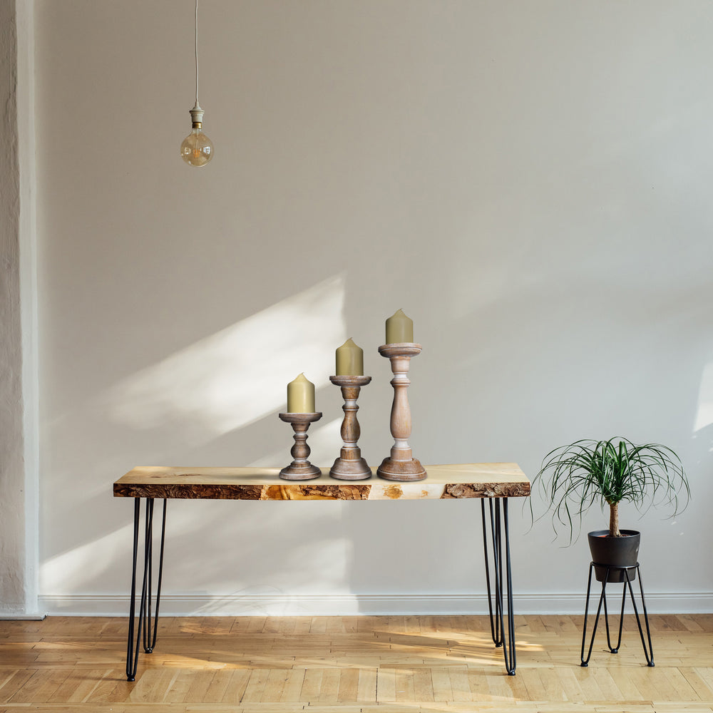 white candleholder set styled on table with candles