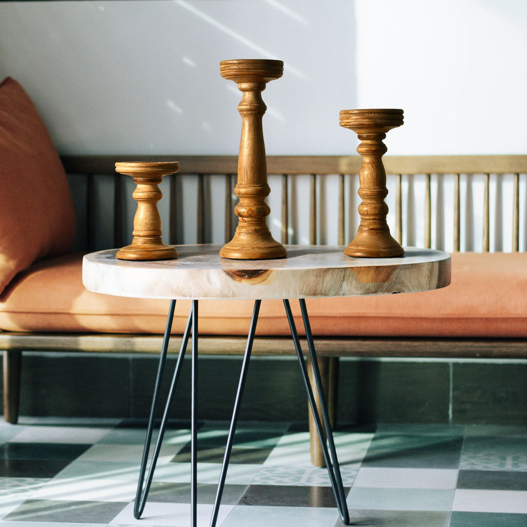 wooden candleholder set styled on table with candles
