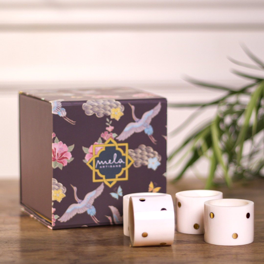 Sitara napkin rings styled on a dining table with cloth napkins during a gathering