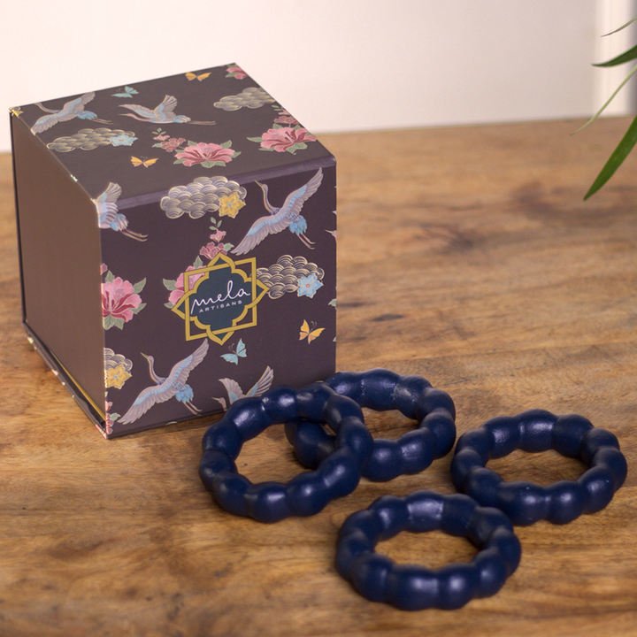 Close-up of handcrafted beaded detailing on terracotta napkin ring
