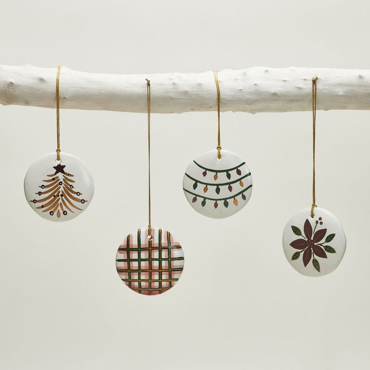 White Frost handcrafted Christmas ornaments decorating a festive holiday tree