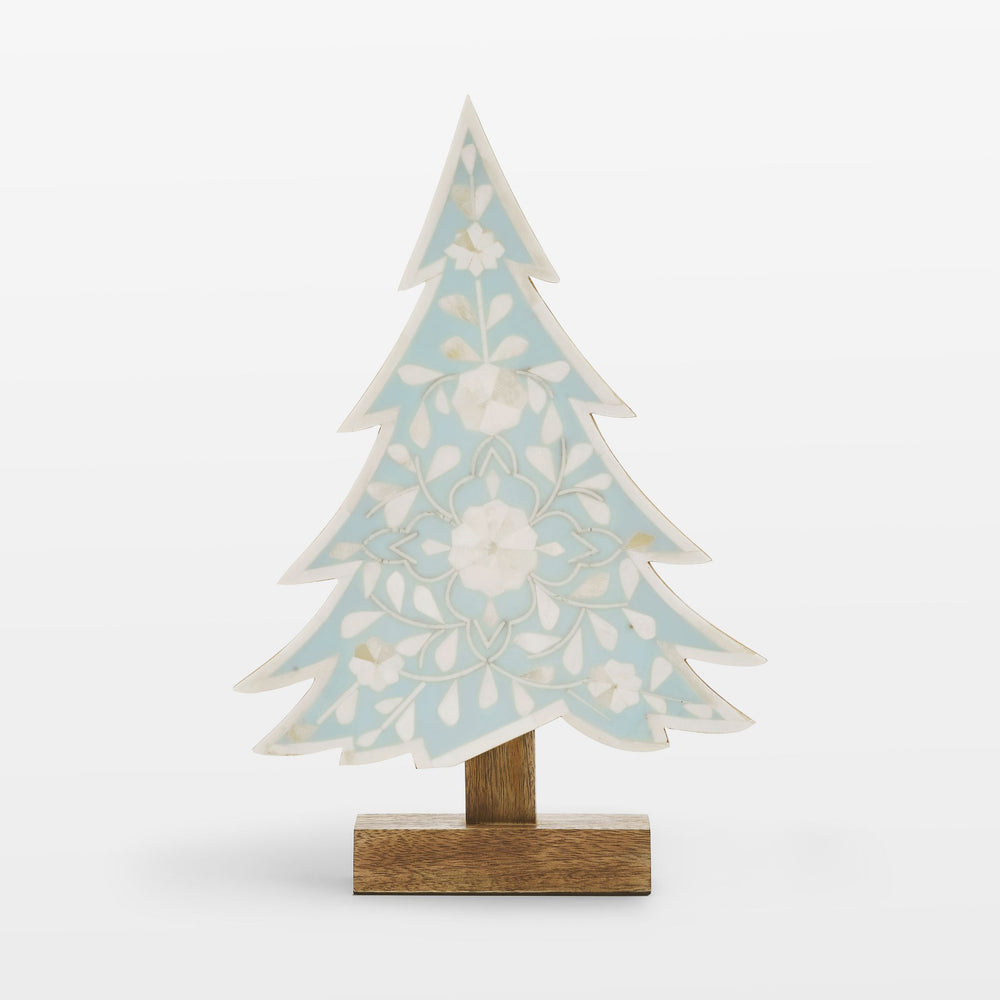 Close-up of handcrafted ivory floral bone inlay pattern set in vibrant teal resin 