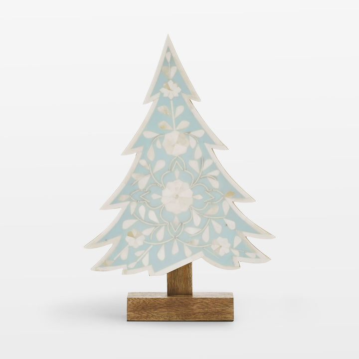Close-up of handcrafted ivory floral bone inlay pattern set in vibrant teal resin 