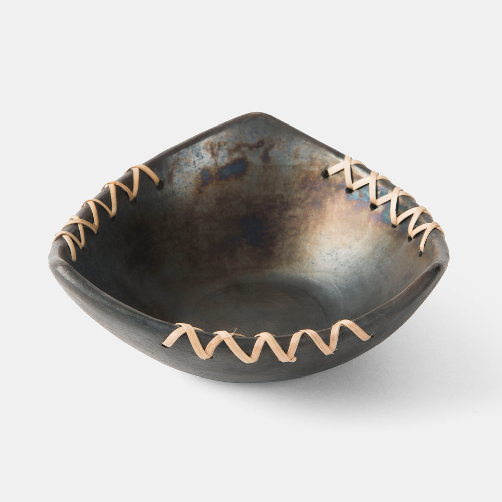 Longpi trigonal black clay nut bowl displayed on tabletop