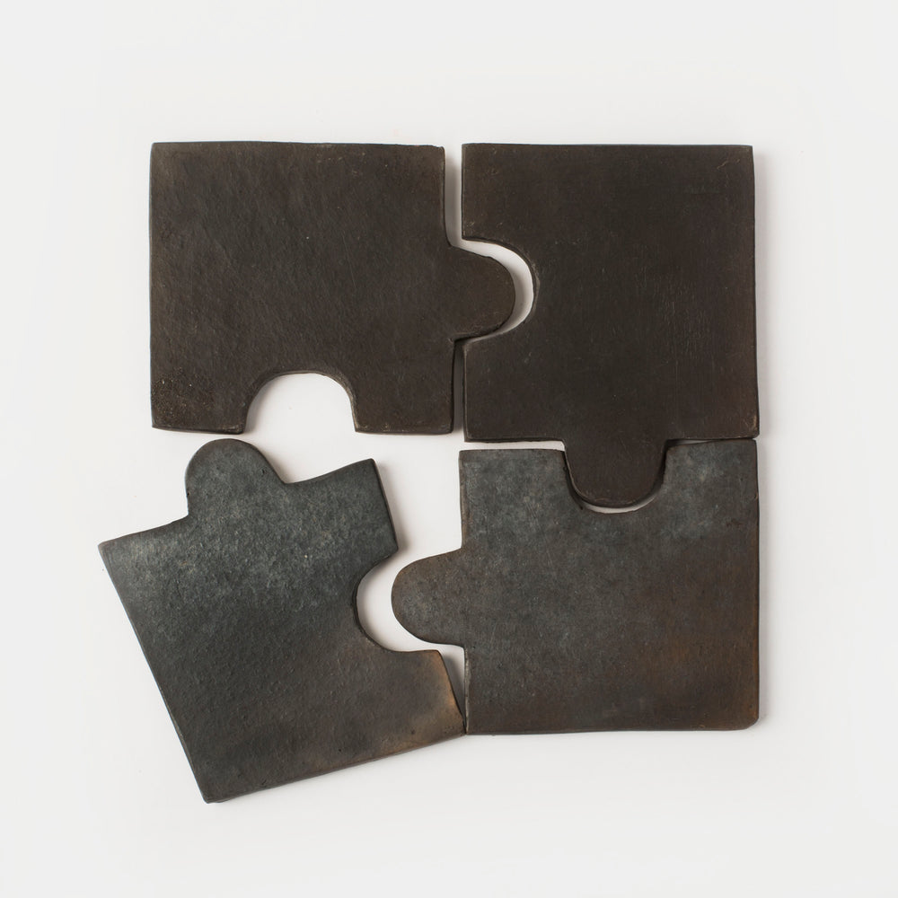 Set of four Longpi black clay coasters in matte finish