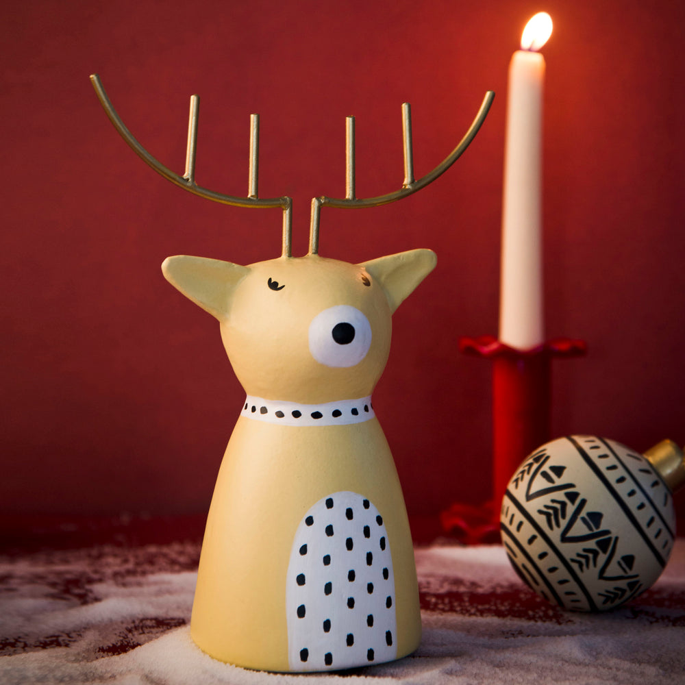 Close-up of golden antlers and hand-painted finish