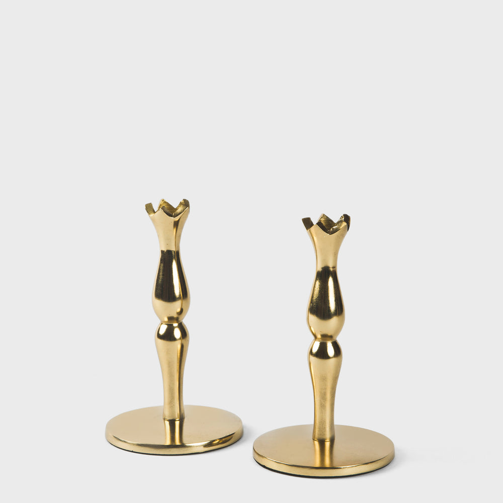 Pair of sleek, gold-toned brass candlesticks with a classic tapered silhouette on a clean white background