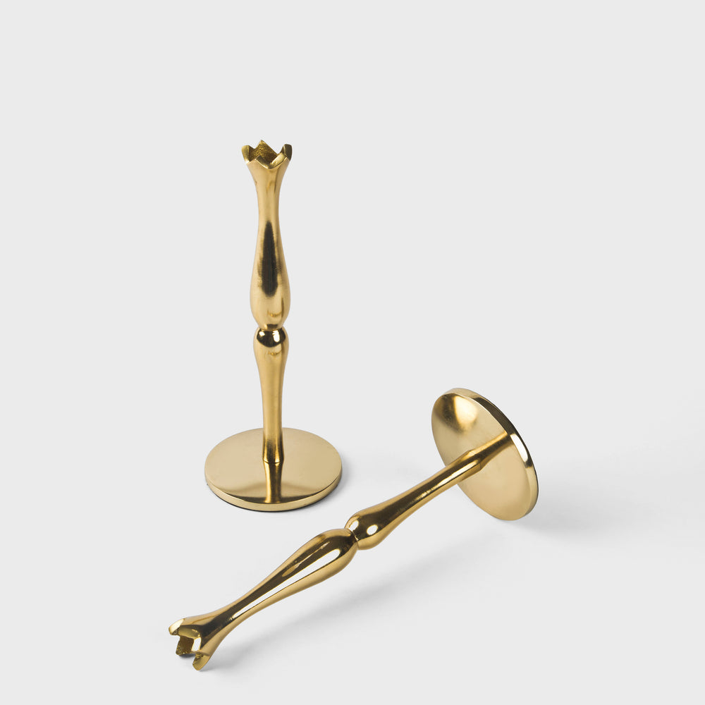 Set of two solid brass candlesticks with a warm gold tone and a timeless, slender silhouette.