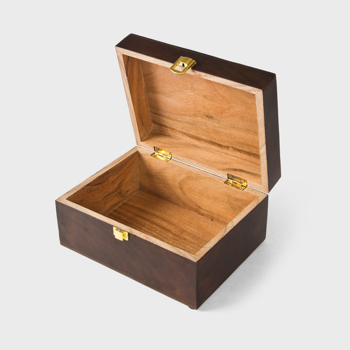 dark walnut acacia wood keepsake storage box styled on dresser with jewelry and accessories
