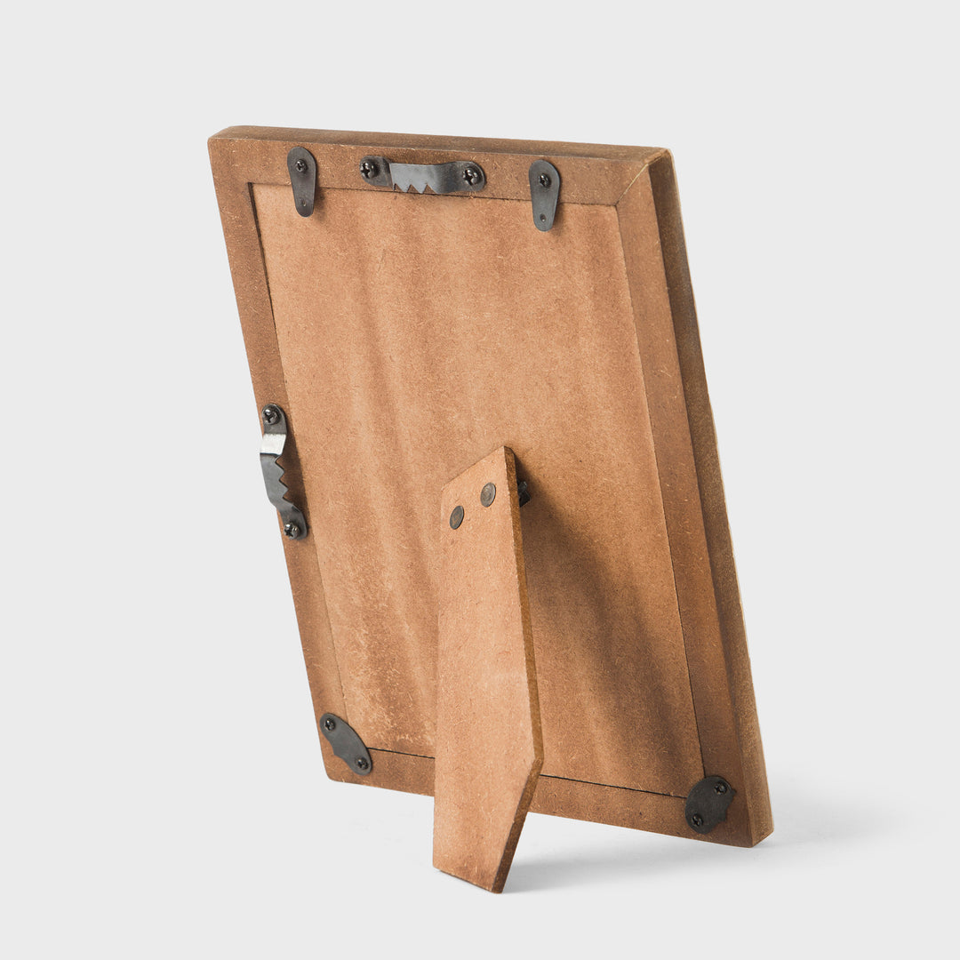 Close-up of white and silver mother of pearl inlay mosaic pattern on handcrafted frame
