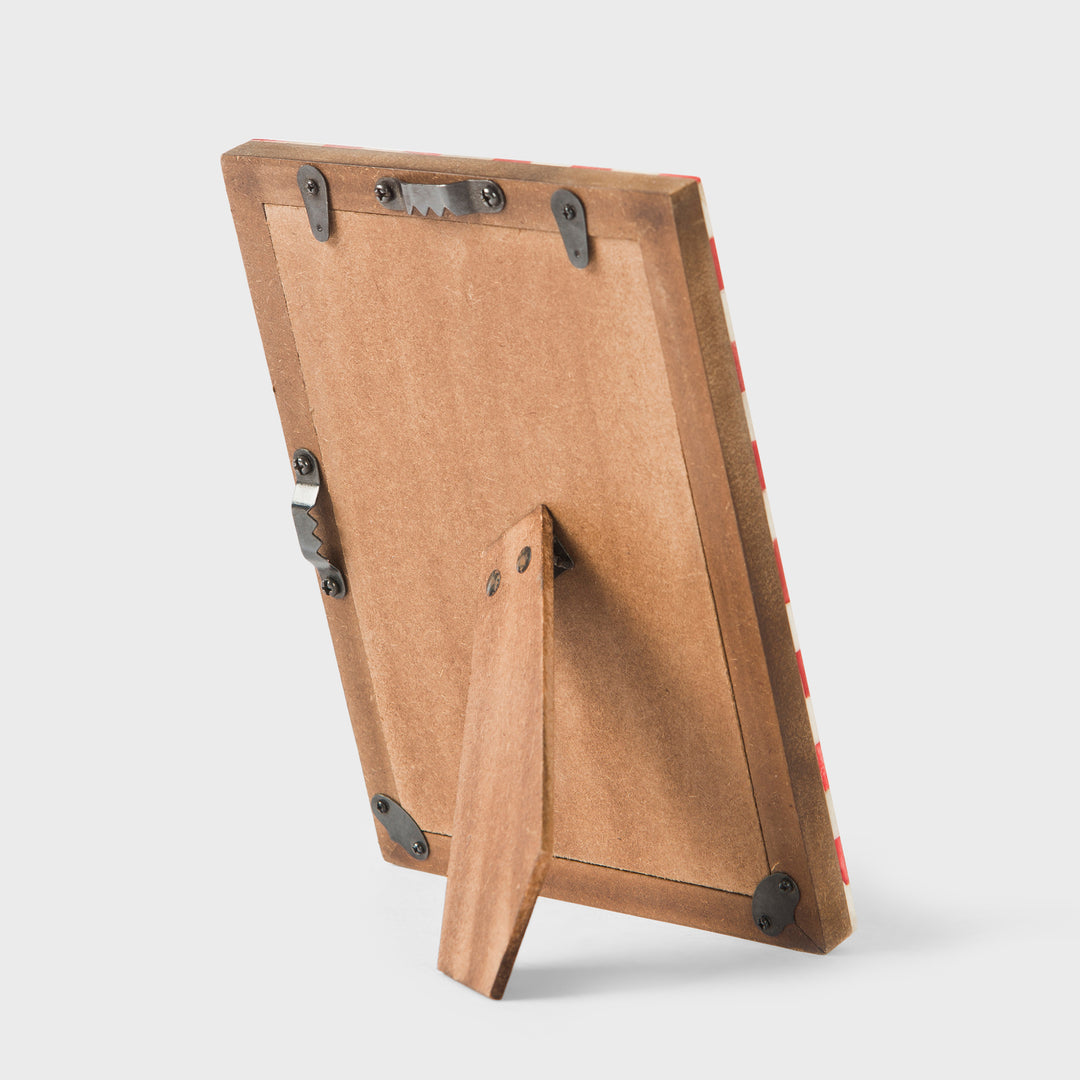Close-up of white and silver mother of pearl inlay mosaic pattern on handcrafted frame
