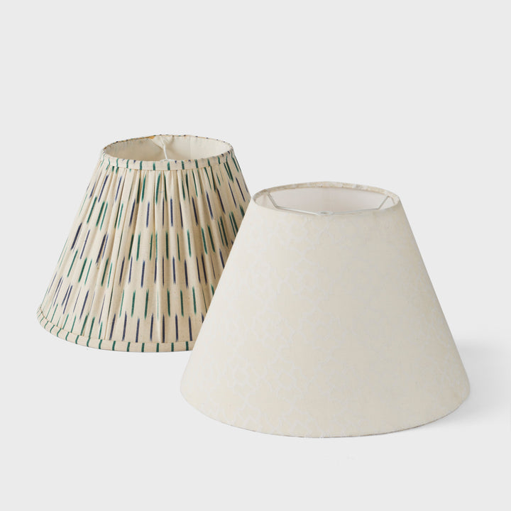 Angled view of both lamp shades highlighting the tapered shape and fabric textures.