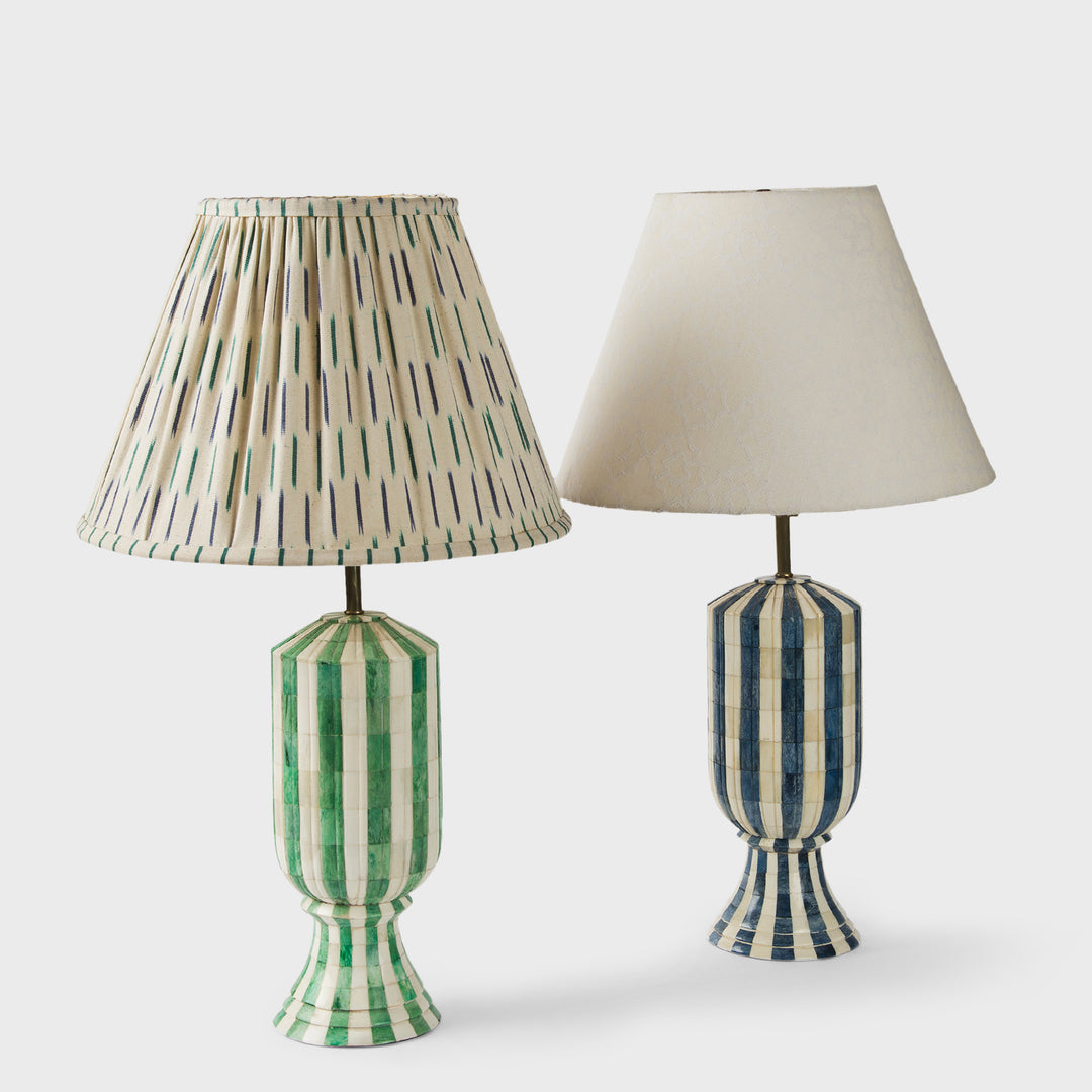 The Linea Duo lamp shades displayed on green glass table lamp bases in a bright room.