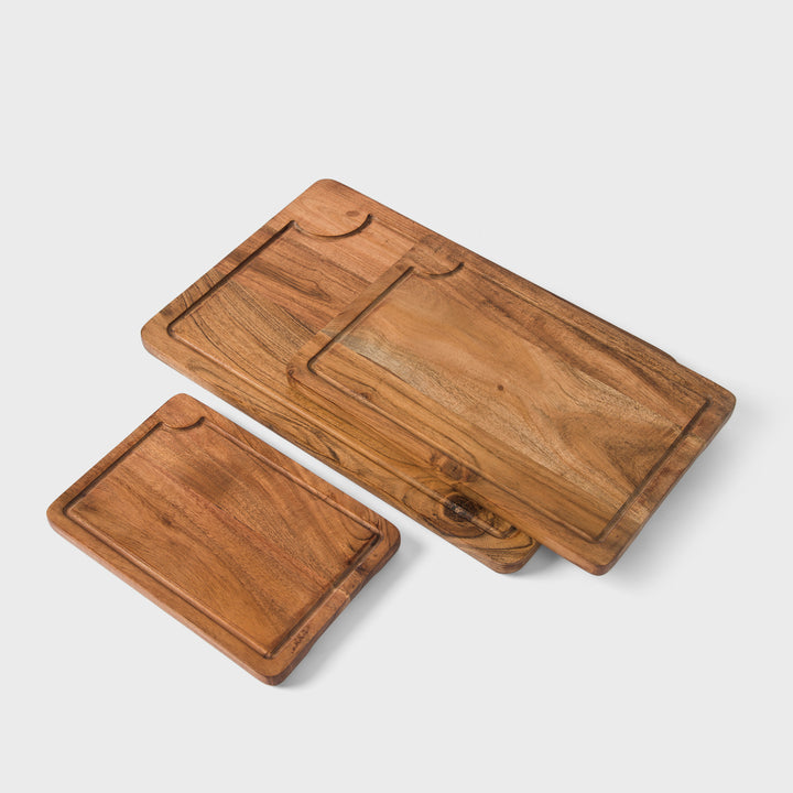 close-up of natural acacia wood grain on handcrafted cutting boards set
