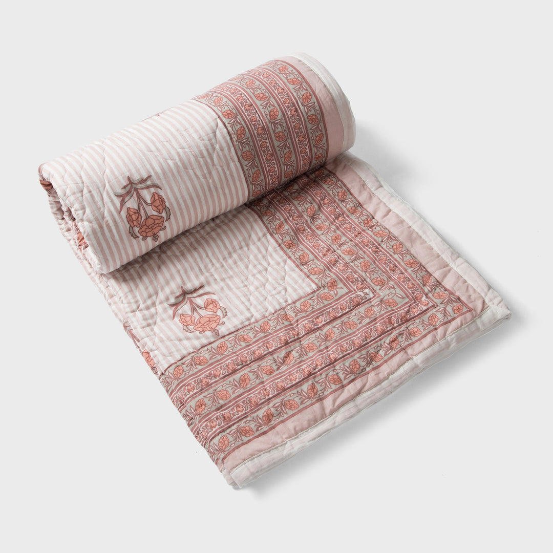  reversible cotton quilt in blush pink with floral and geometric patterns