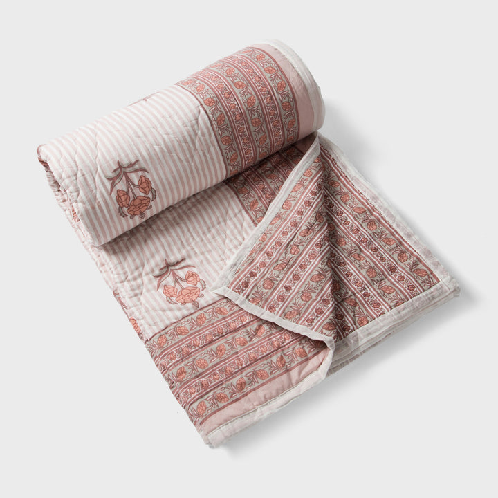  reversible cotton quilt in blush pink with floral and geometric patterns