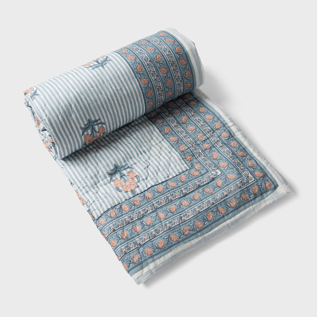  reversible cotton quilt in blue with floral and geometric patterns