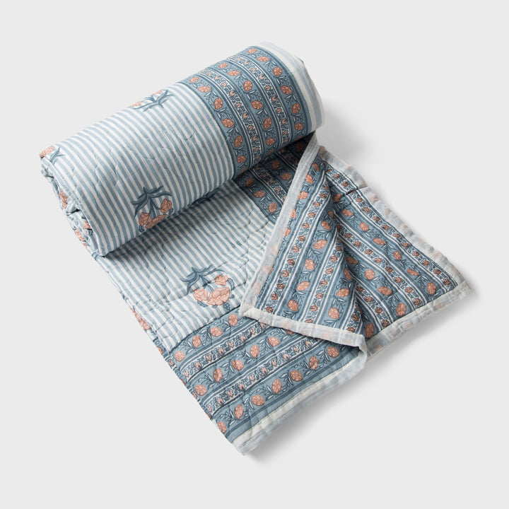  reversible cotton quilt in blue with floral and geometric patterns