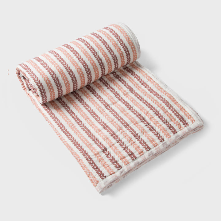 Close-up of cotton fabric texture and leafy stripe pattern on quilt