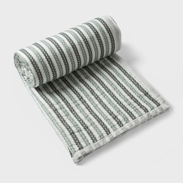 Lehar cotton quilt styled on bedroom setting with pillows and décor
