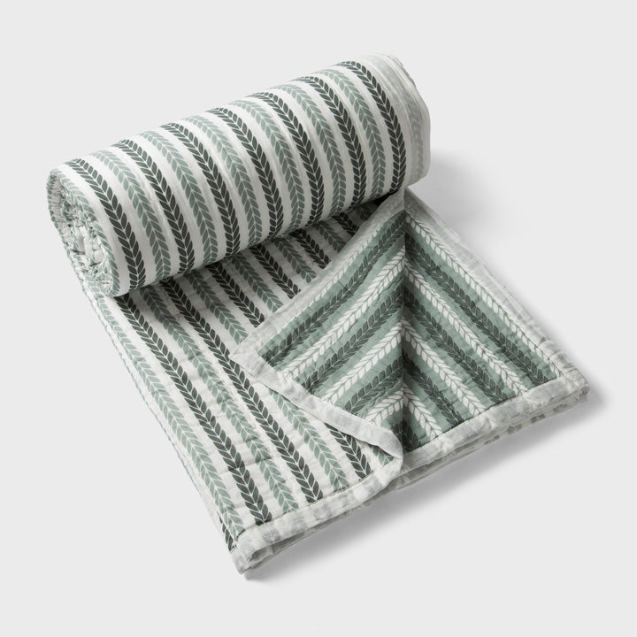 Lehar cotton quilt styled on bedroom setting with pillows and décor
