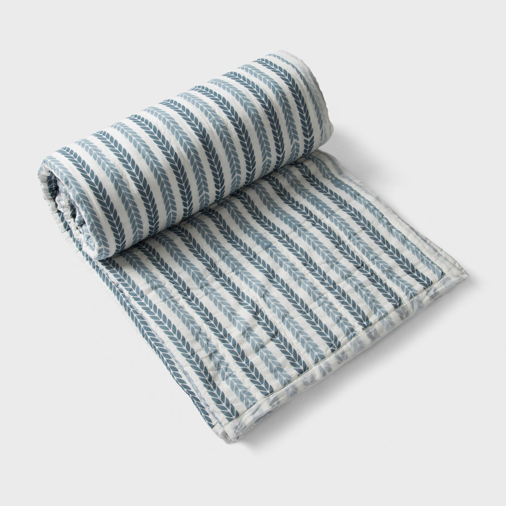 Lehar cotton quilt styled on bedroom setting with pillows and décor