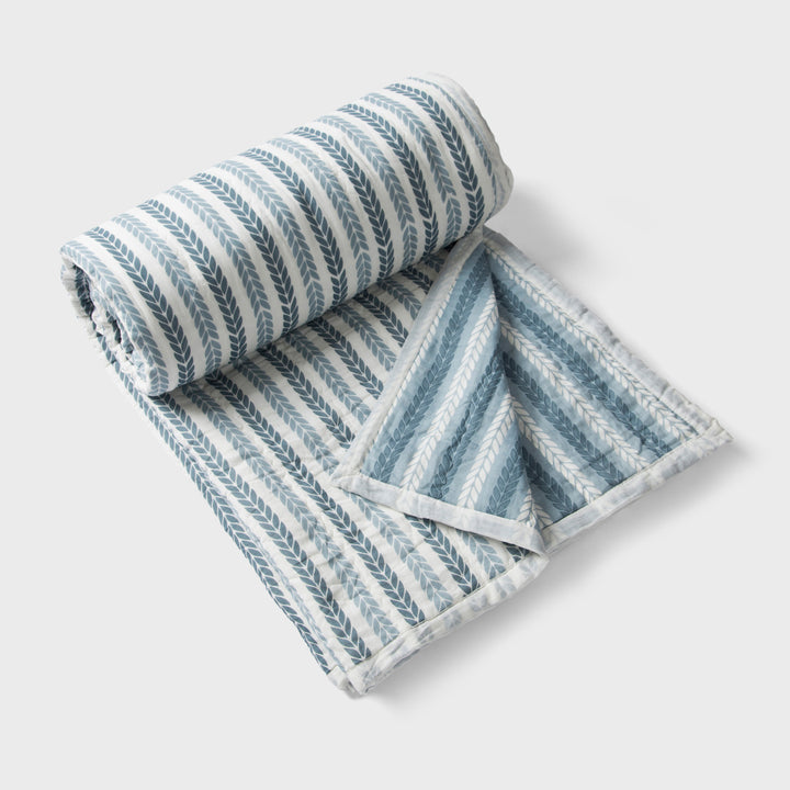 Lehar cotton quilt styled on bedroom setting with pillows and décor