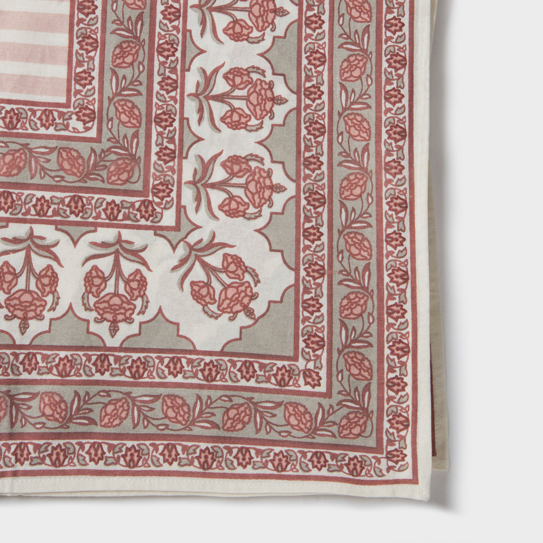 Gulshan tablecloth styled on dining table with plates, napkins, and décor
