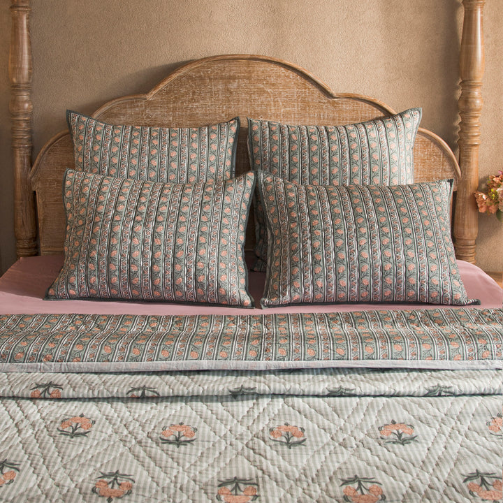 Kunj reversible cotton quilt in green with floral and geometric patterns