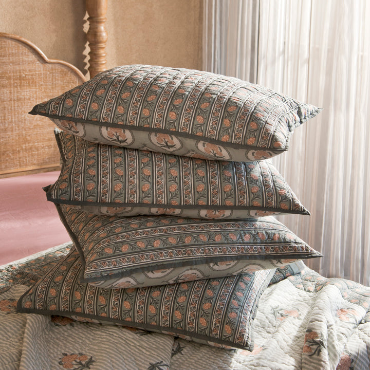 Kunj euro green shams styled on a bed layered with quilt and cushions
