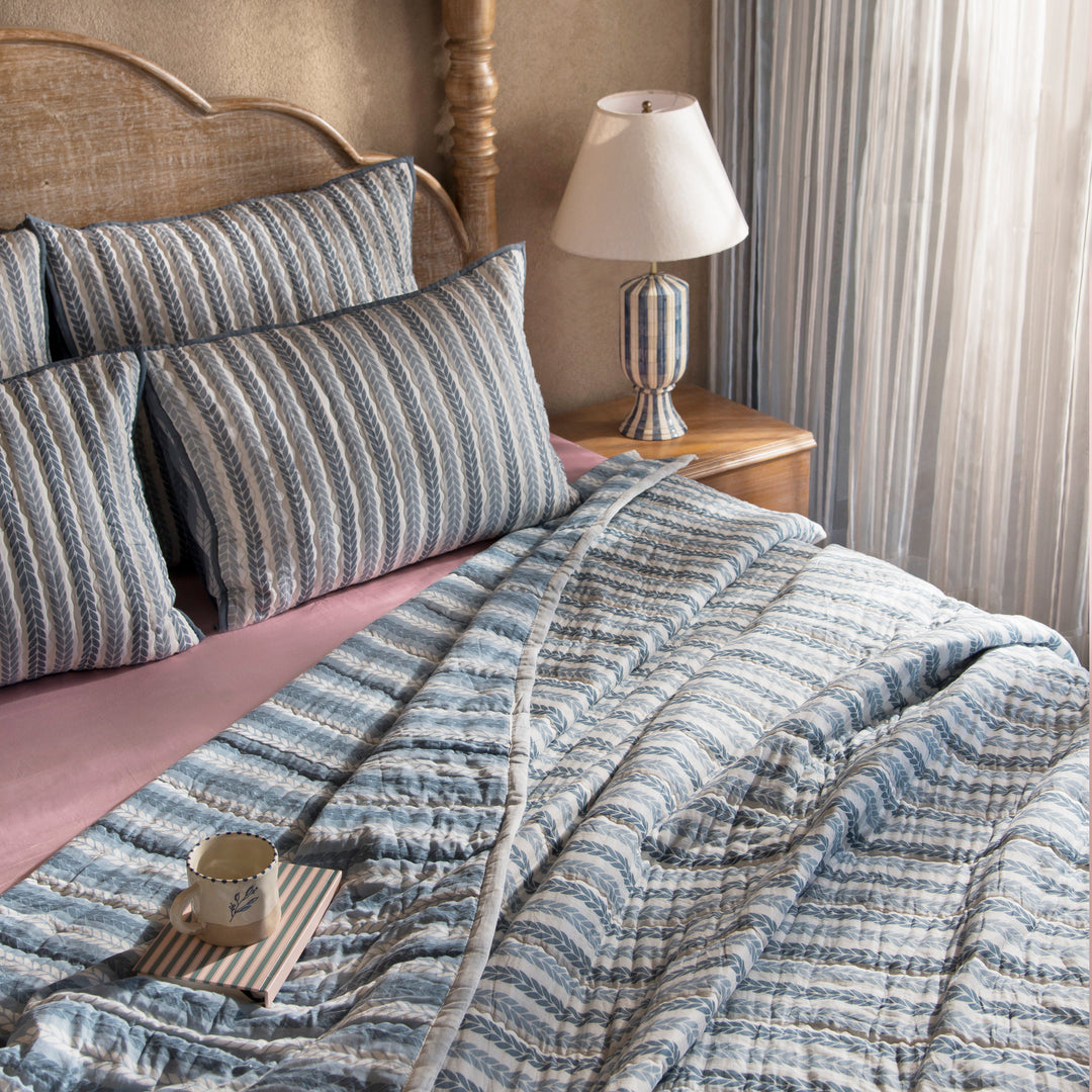 Close-up of cotton fabric texture and leafy stripe pattern on quilt
