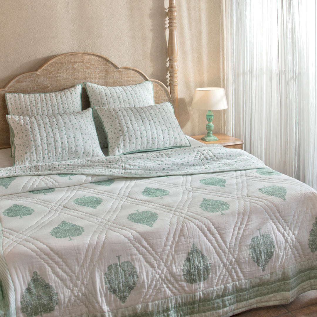 Zahra cotton quiltted bed cover styled on bedroom setting with pillows and décor