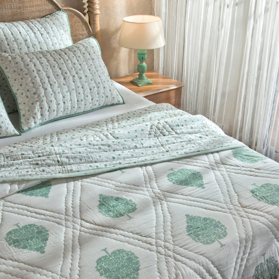 Zahra cotton quiltted bed cover styled on bedroom setting with pillows and décor