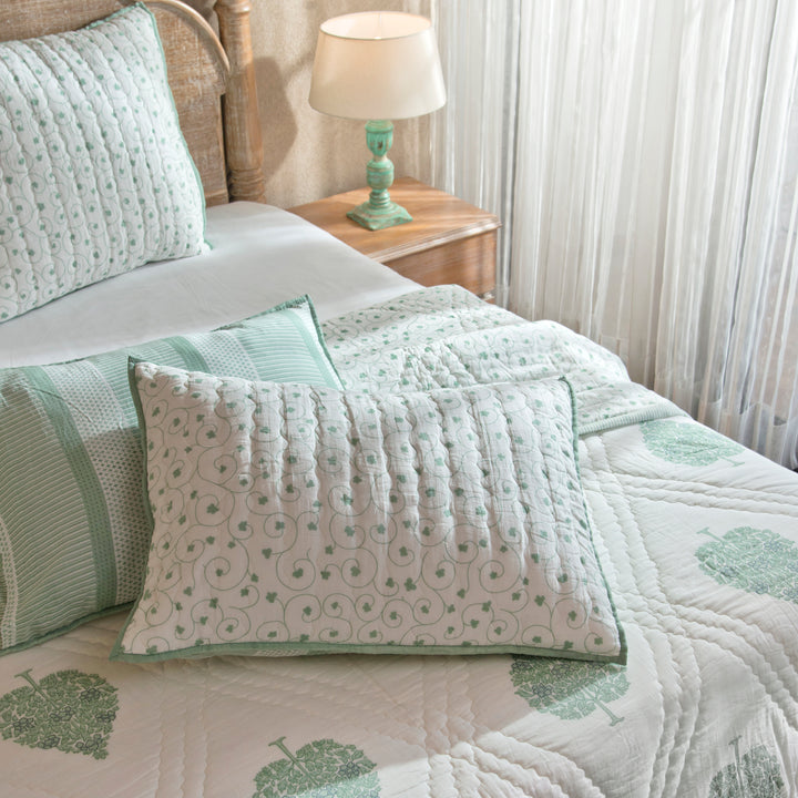 Zahra euro shams styled on a bed layered with quilt and cushions