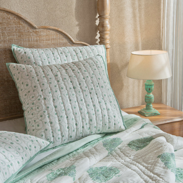 Zahra euro shams styled on a bed layered with quilt and cushions