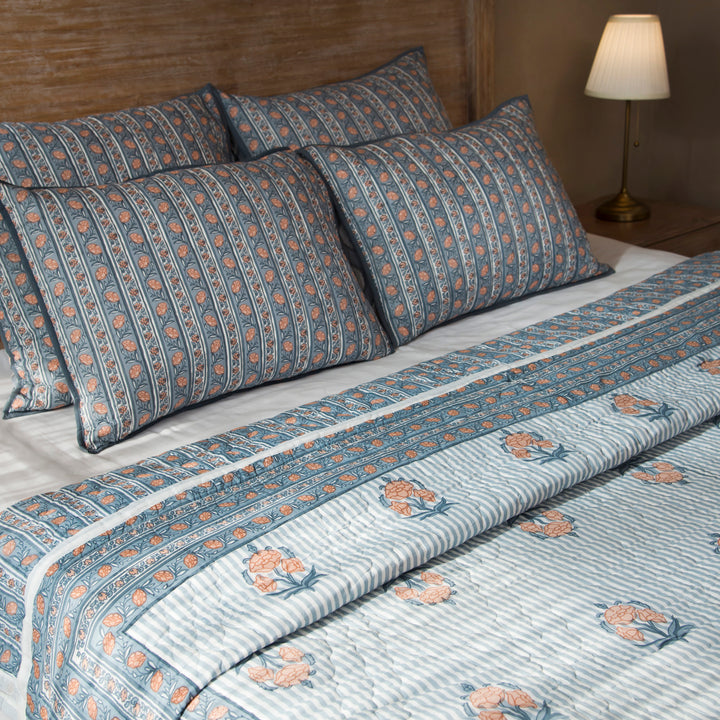Kunj reversible cotton quilt in blue with floral and geometric patterns