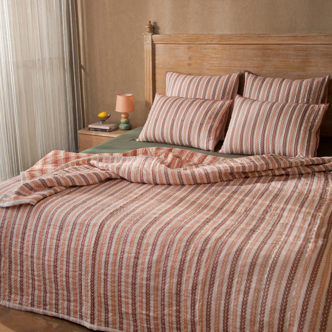 Close-up of cotton fabric texture and leafy stripe pattern on quilt