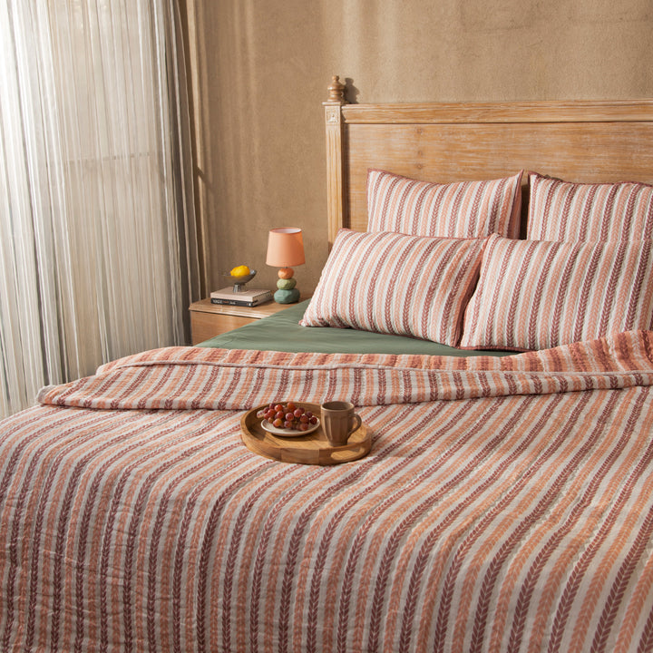 Close-up of cotton fabric texture and leafy stripe pattern on quilt
