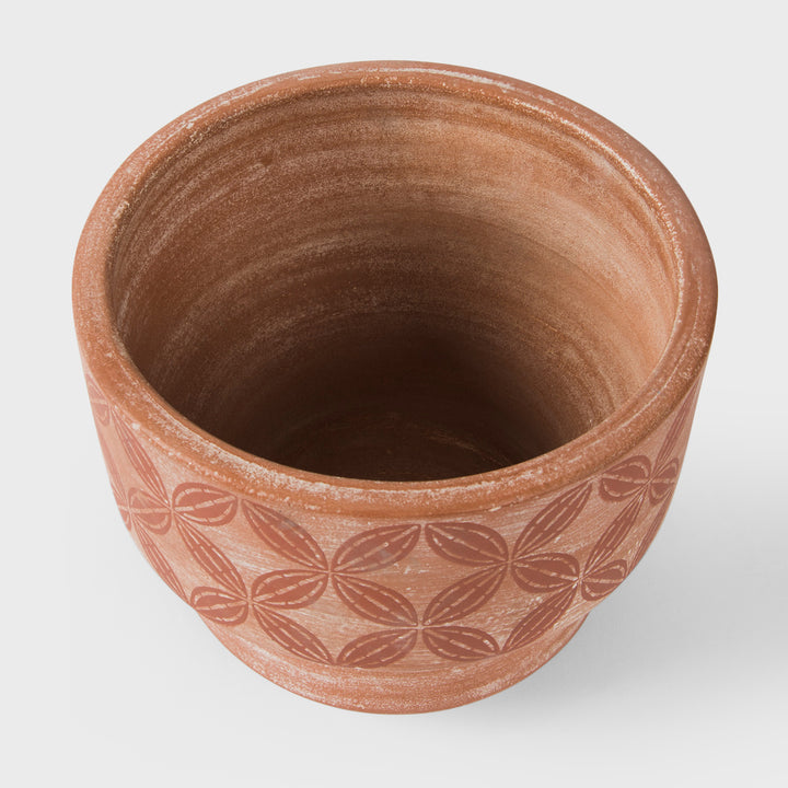 Close-up of stepped profile raw terracotta clay and hand painted cream and ochre band detail  