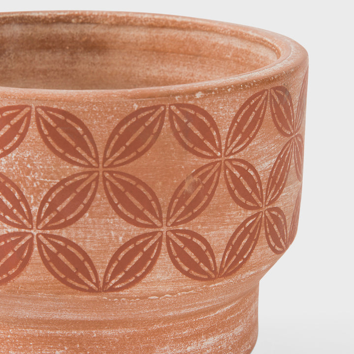 Close-up of stepped profile raw terracotta clay and hand painted cream and ochre band detail  