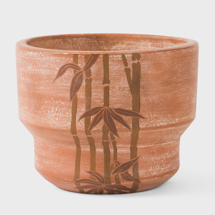 Hand painted bamboo grove terracotta 7 diameter planter with ochre and white leaves on a natural clay background  