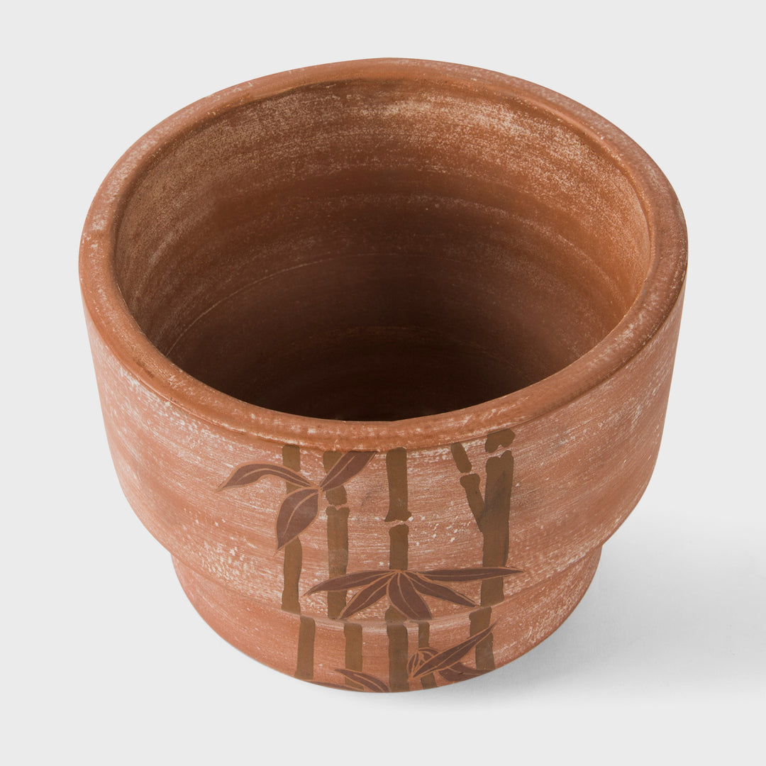 Hand painted bamboo grove terracotta 7 diameter planter with ochre and white leaves on a natural clay background  