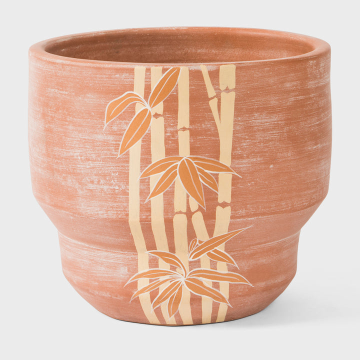 Hand painted bamboo grove terracotta 8.5 diameter planter with ochre and white leaves on a natural clay background  