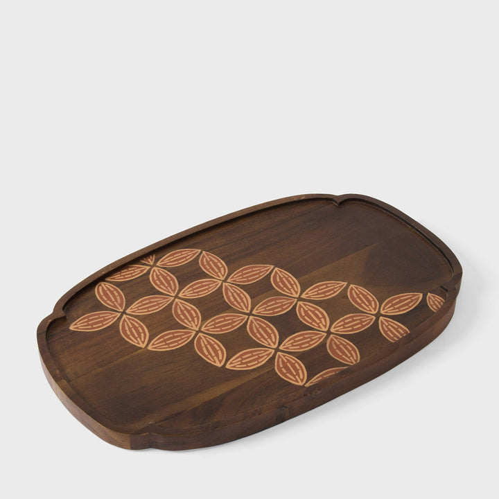  Close-up of scalloped rim profile and hand painted terracotta and cream leaf detail on natural wood