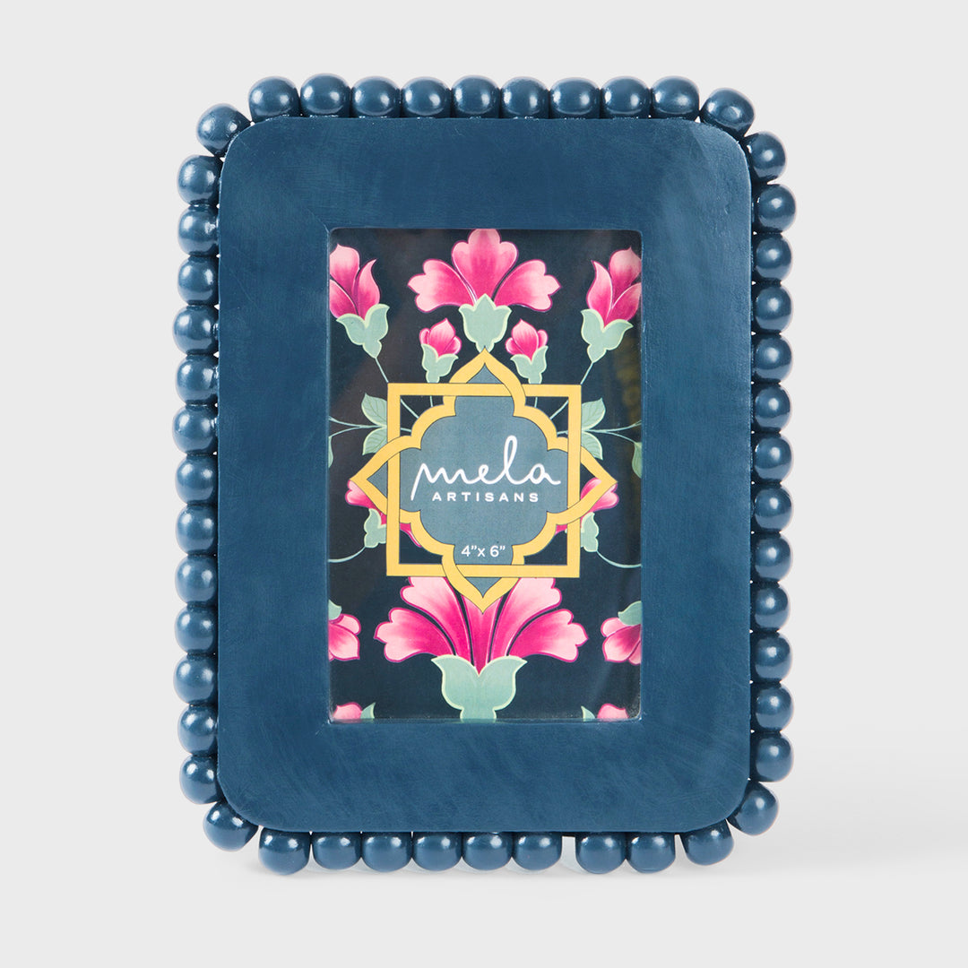 Handcrafted matte indigo mango wood 4 x 6 photo frame with a hand-carved raised beaded border by Mela Artisans.