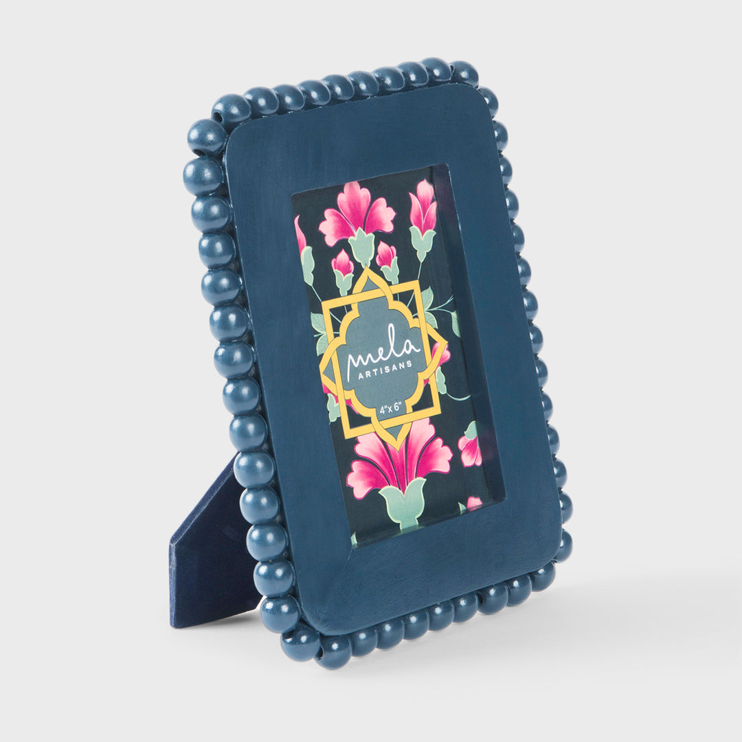 Handcrafted matte indigo mango wood 4 x 6 photo frame with a hand-carved raised beaded border by Mela Artisans.