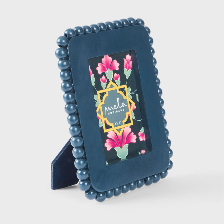 Handcrafted matte indigo mango wood 4 x 6 photo frame with a hand-carved raised beaded border by Mela Artisans.