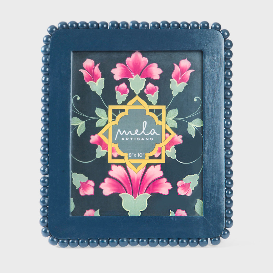 Handcrafted matte indigo mango wood 8 x 10 photo frame with a hand-carved raised beaded border by Mela Artisans.